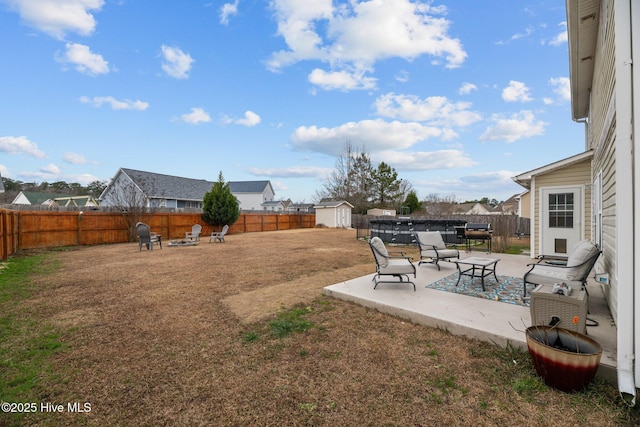 view of yard featuring a patio area and a storage shed