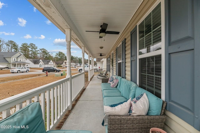 balcony featuring covered porch and ceiling fan