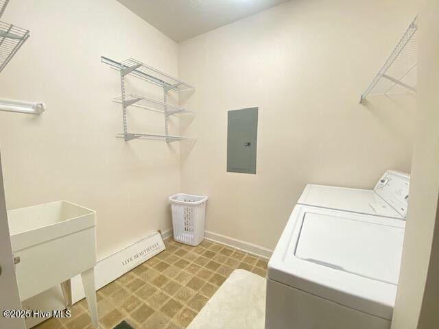 clothes washing area with separate washer and dryer, sink, and electric panel