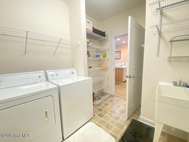 laundry room featuring washing machine and dryer and sink