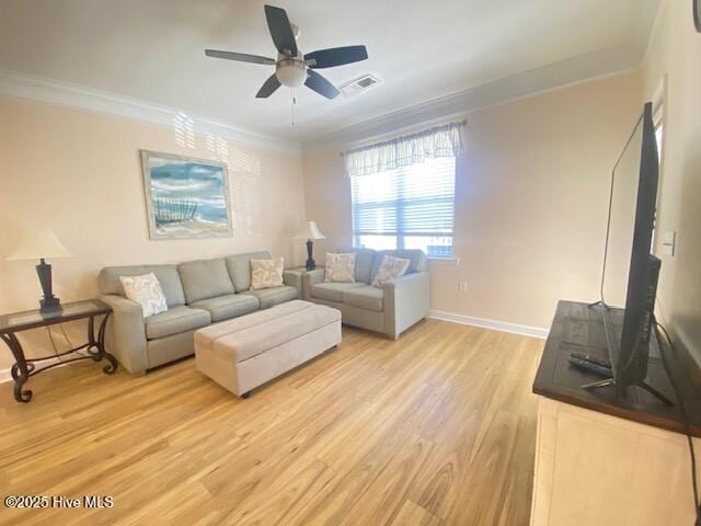 living room featuring ceiling fan, ornamental molding, and light hardwood / wood-style flooring