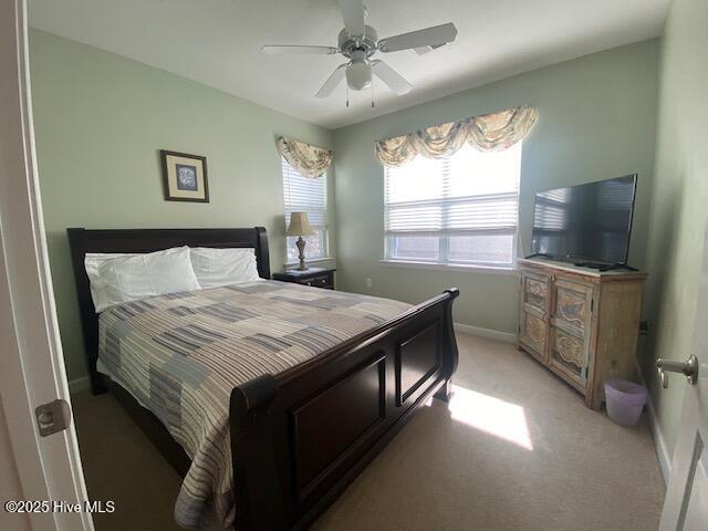 carpeted bedroom with ceiling fan