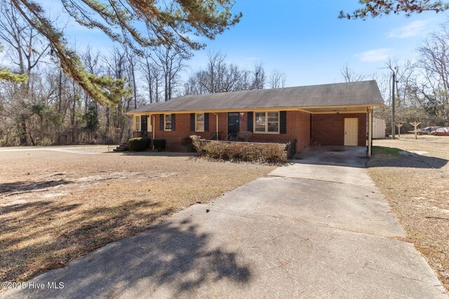 ranch-style home featuring a carport