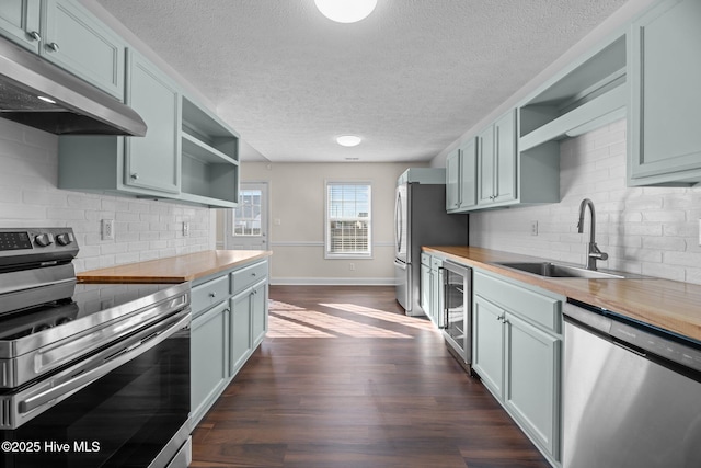 kitchen featuring sink, wine cooler, decorative backsplash, appliances with stainless steel finishes, and butcher block counters