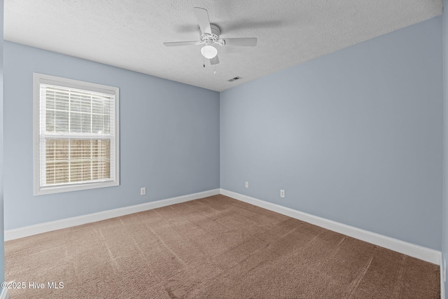 empty room featuring carpet, a textured ceiling, and ceiling fan