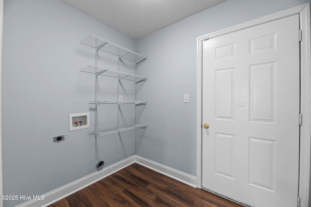 laundry area with a textured ceiling, washer hookup, dark hardwood / wood-style floors, and hookup for an electric dryer