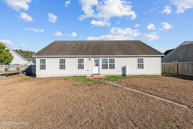 back of house featuring a lawn