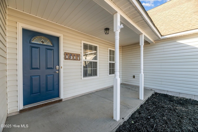 view of exterior entry featuring a porch