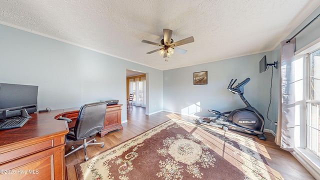 office area with hardwood / wood-style floors, a textured ceiling, a wealth of natural light, and ceiling fan