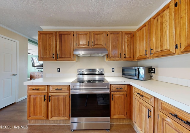 kitchen featuring a textured ceiling, crown molding, and stainless steel appliances