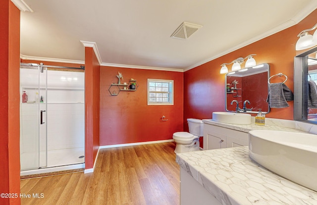 bathroom with vanity, hardwood / wood-style flooring, an enclosed shower, and ornamental molding