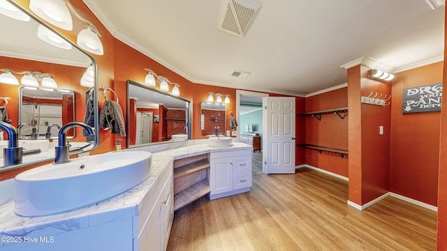 bathroom featuring hardwood / wood-style floors, vanity, and ornamental molding