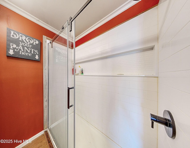 bathroom with walk in shower, hardwood / wood-style flooring, and ornamental molding