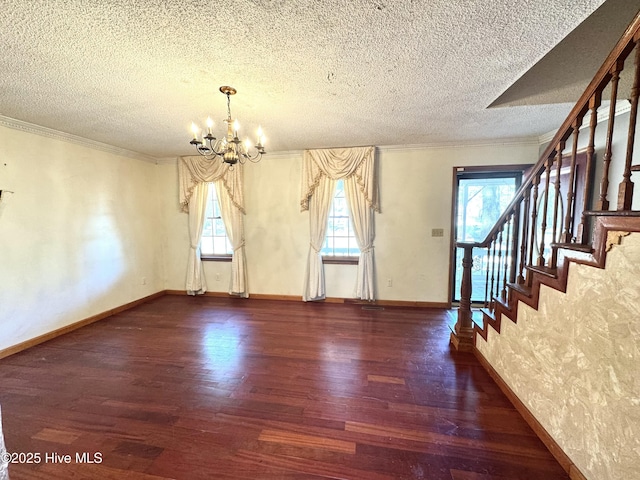 interior space with a textured ceiling, ornamental molding, dark hardwood / wood-style floors, and a chandelier