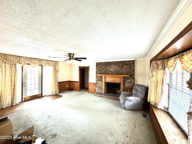 unfurnished living room featuring carpet floors, a textured ceiling, and a fireplace