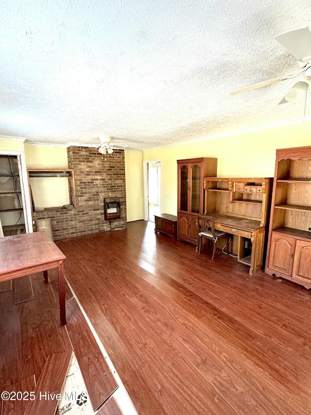 living room featuring dark hardwood / wood-style flooring, a textured ceiling, a fireplace, and ceiling fan