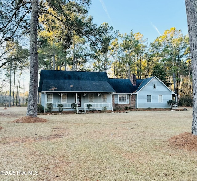 ranch-style home with covered porch and a front lawn