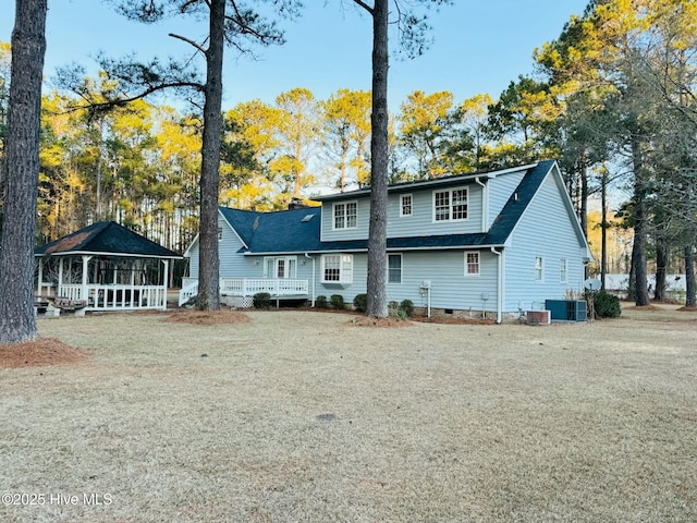 back of house with a gazebo, central AC, and a lawn