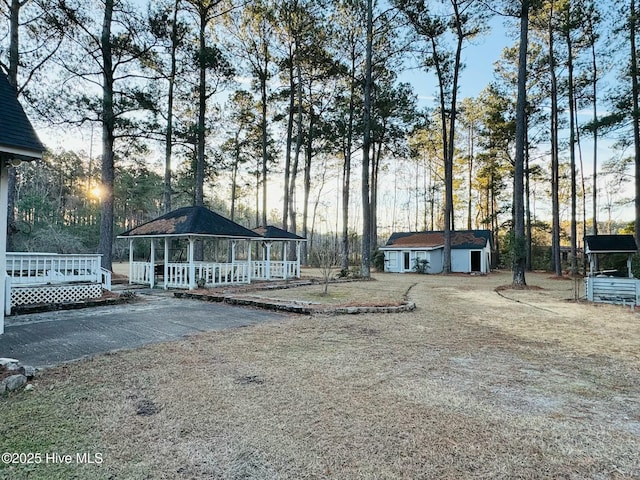 view of front of house with a storage shed and a porch