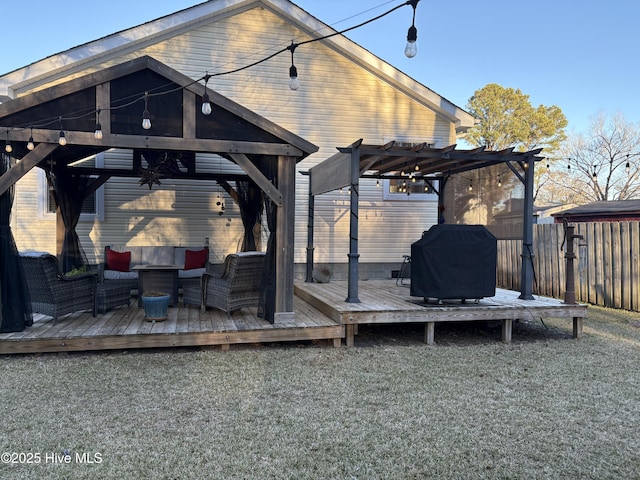 wooden terrace with a lawn, area for grilling, a pergola, and an outdoor living space