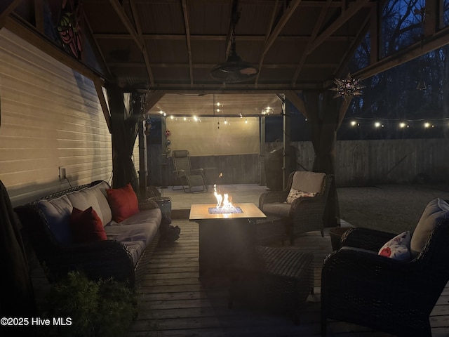 exterior space featuring ceiling fan and an outdoor living space with a fire pit