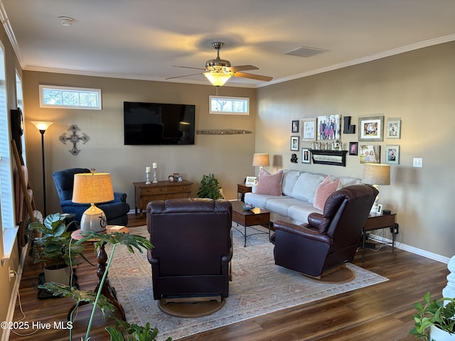 living room with dark hardwood / wood-style flooring, ceiling fan, a healthy amount of sunlight, and crown molding