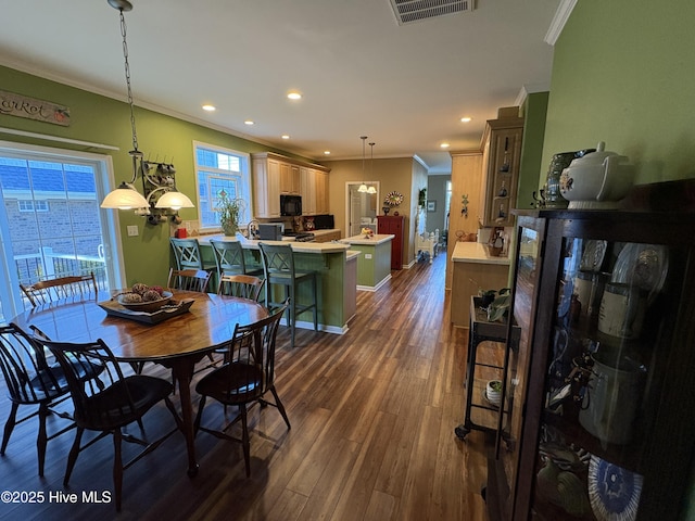 dining area featuring crown molding and dark hardwood / wood-style floors