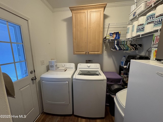 clothes washing area with dark hardwood / wood-style flooring, washing machine and clothes dryer, ornamental molding, and cabinets