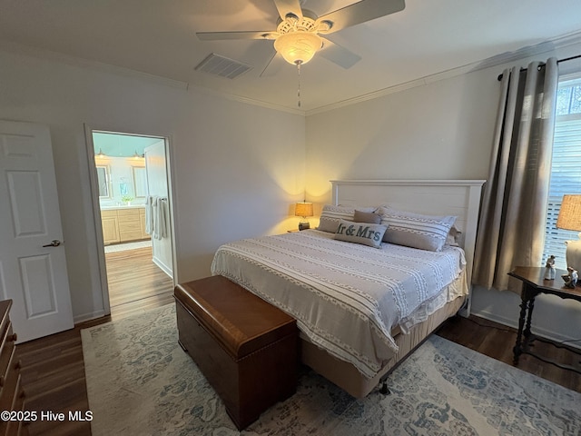 bedroom featuring ceiling fan, dark wood-type flooring, ornamental molding, and ensuite bathroom