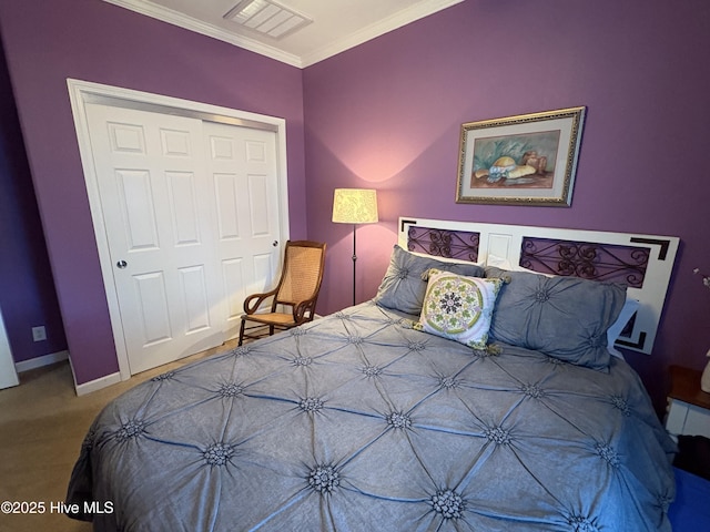 bedroom with carpet floors, a closet, and crown molding