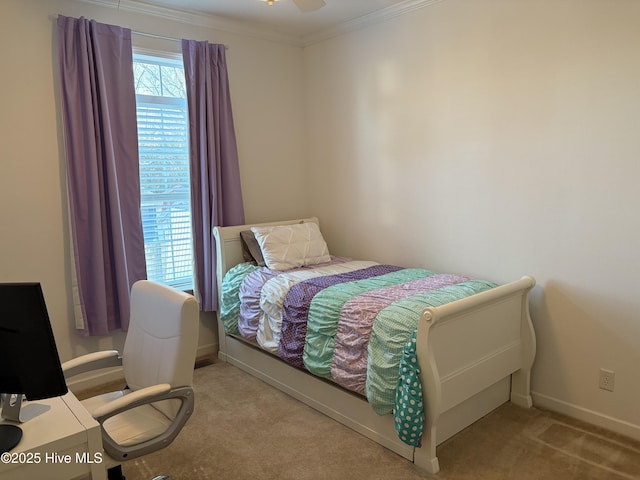 bedroom featuring ceiling fan, ornamental molding, and light carpet