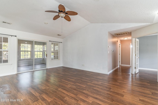 empty room with ceiling fan, dark hardwood / wood-style flooring, lofted ceiling, and a textured ceiling