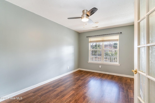 spare room with a textured ceiling, dark hardwood / wood-style floors, and ceiling fan