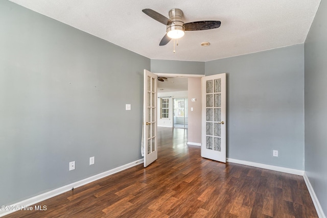 empty room featuring french doors, dark hardwood / wood-style flooring, and ceiling fan