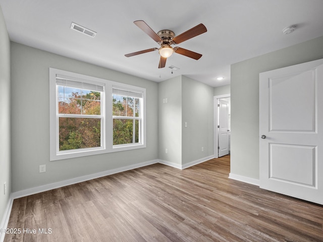 empty room featuring ceiling fan and light hardwood / wood-style floors