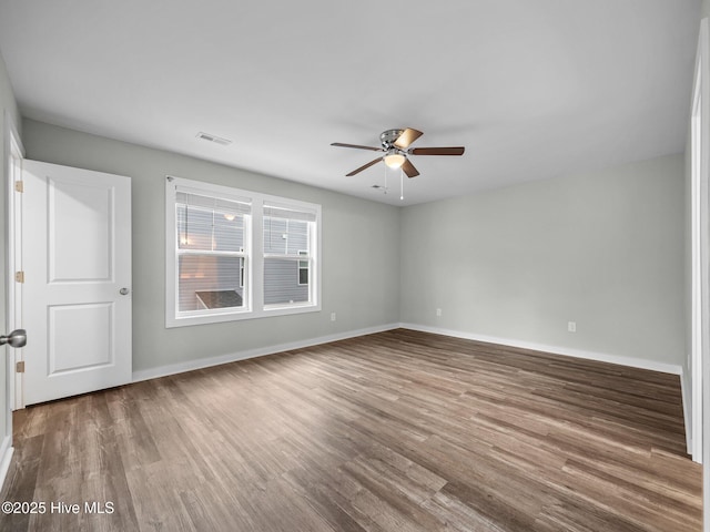 unfurnished room with hardwood / wood-style flooring and ceiling fan