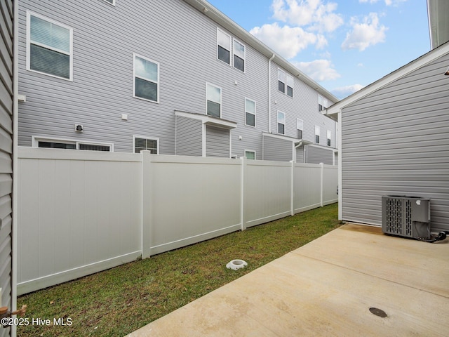 view of yard with a patio area and central air condition unit