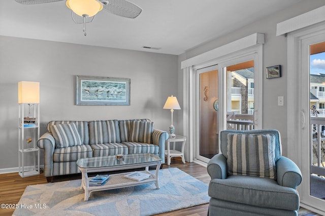 living room featuring hardwood / wood-style flooring and ceiling fan