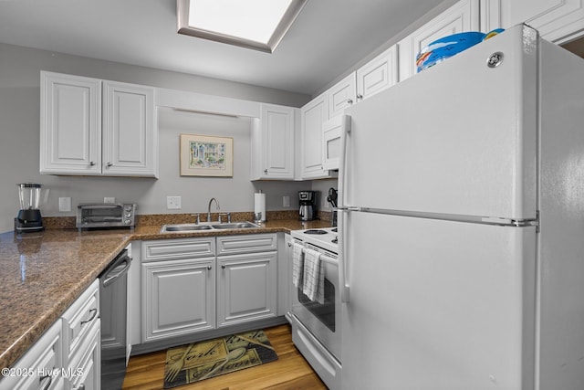 kitchen featuring white cabinets, light wood-type flooring, white appliances, and sink