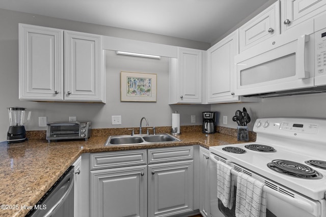 kitchen featuring sink, white cabinets, and white appliances