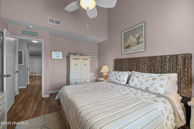 bedroom with ceiling fan and dark hardwood / wood-style flooring