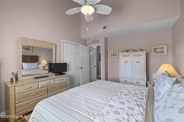 bedroom featuring a high ceiling, a closet, and ceiling fan