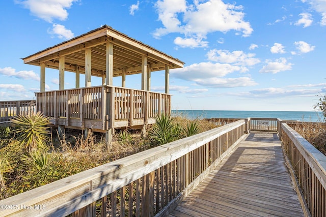 dock area featuring a water view and a view of the beach