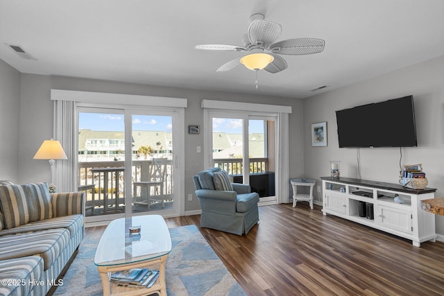 living room with ceiling fan and dark hardwood / wood-style floors