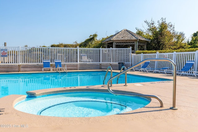 view of pool with a gazebo, a patio, and a hot tub