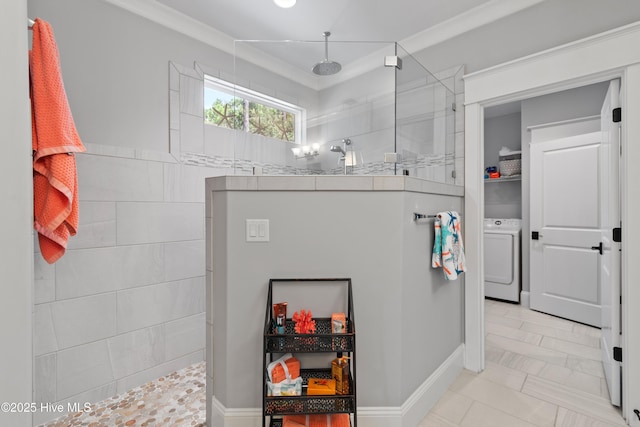 bathroom with a shower, washer / dryer, tile patterned floors, and crown molding