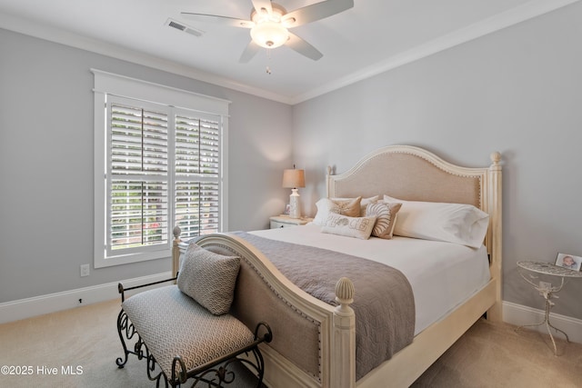 carpeted bedroom with ceiling fan and ornamental molding