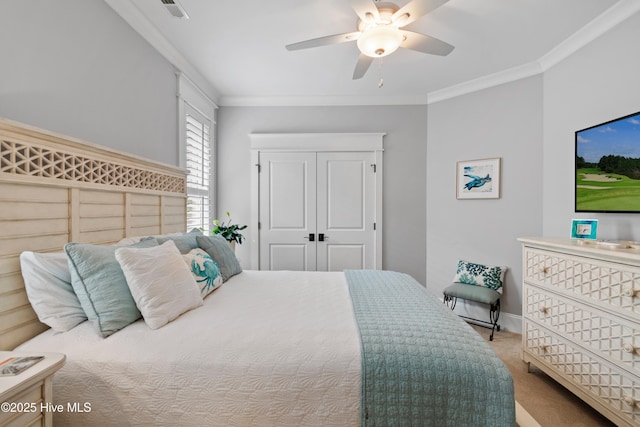 bedroom featuring carpet flooring, ceiling fan, and crown molding