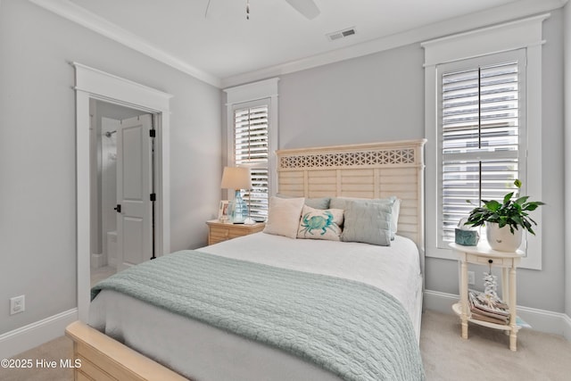 bedroom featuring ceiling fan, carpet floors, ornamental molding, and ensuite bath