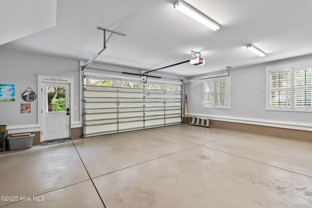 garage featuring electric water heater, a garage door opener, and white refrigerator